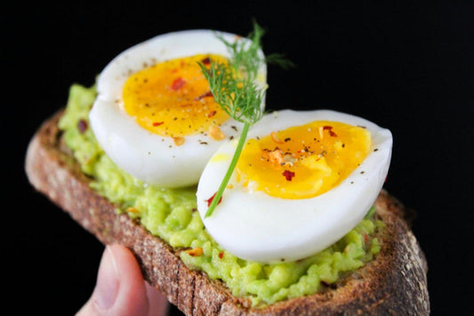 slice of wholegrain bread with avocado spread and boiled egg – natural biotin-rich food for a balanced UK diet
