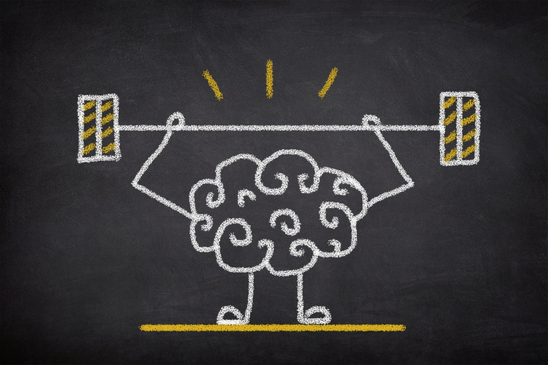 Chalk drawing of a brain with arms and legs lifting a barbell, symbolising the neuroprotective effects of astaxanthin and omega-3.