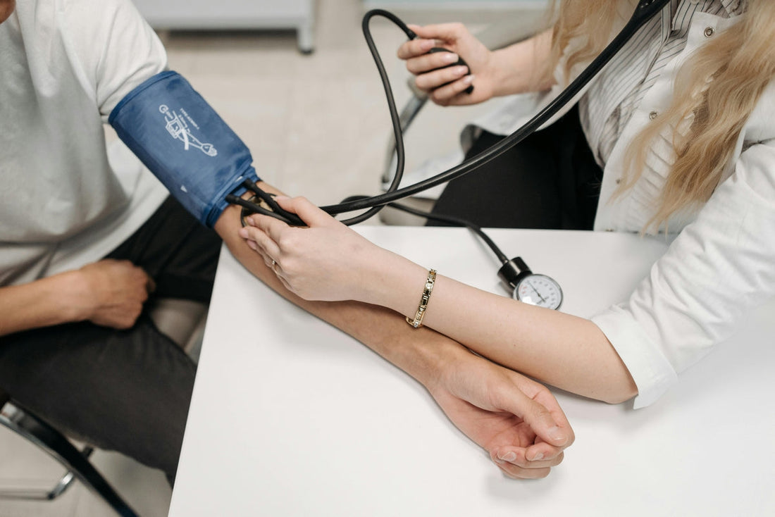 A doctor measures a patient's blood pressure to check for signs of hypertension. This image illustrates an article on how magnesium can support heart health and healthy blood pressure