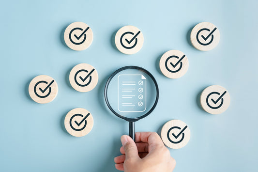 Magnifying glass highlighting a checklist with ticks, symbolising clinical research on L-methylfolate and folic acid benefits.