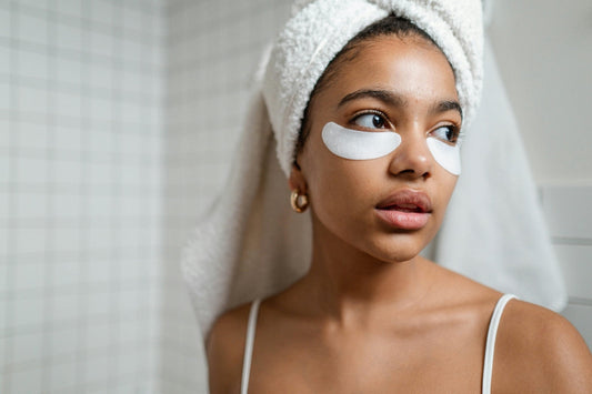 Woman with a towel on her head and glowing skin, highlighting the benefits of nutritional supplements for skin health.