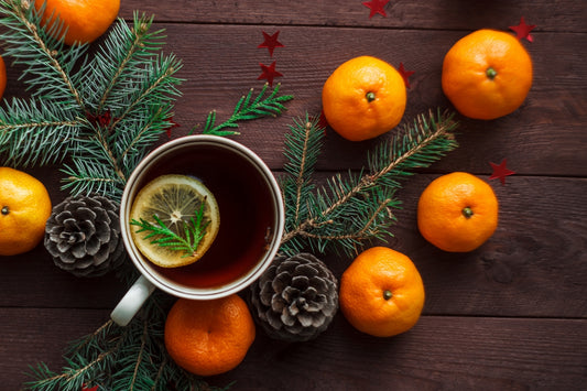 Oranges in a winter setting with pinecones, highlighting natural vitamin C for boosting immunity during cold and flu season.